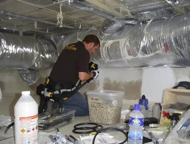 Stoneham Air Duct Cleaning specialist performing professional mold removal from air ducts in Stoneham