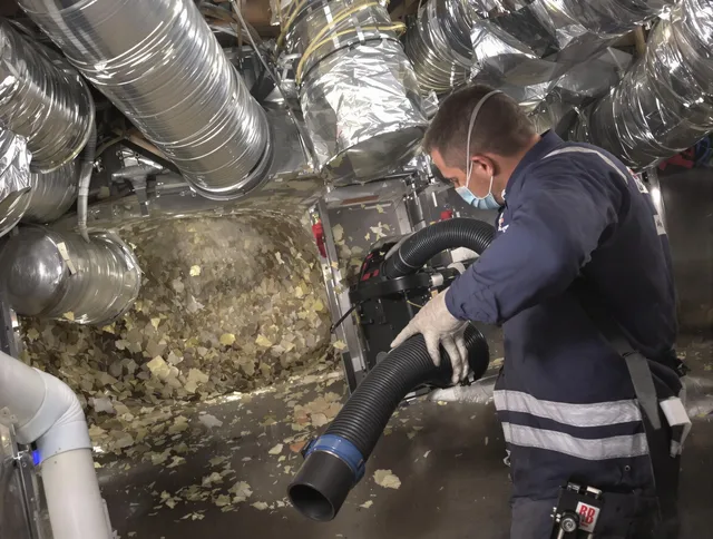 Stoneham Air Duct Cleaning specialist operating negative pressure cleaning equipment for thorough duct maintenance in Stoneham