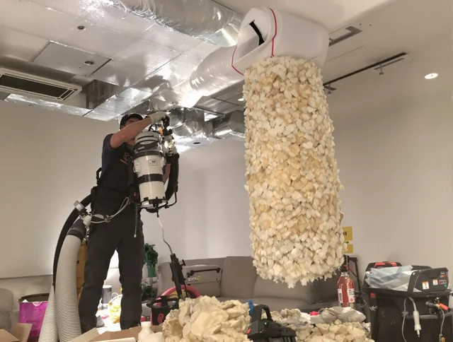 Stoneham Air Duct Cleaning technician performing precision vacuum insulation removal in a residential property in Stoneham