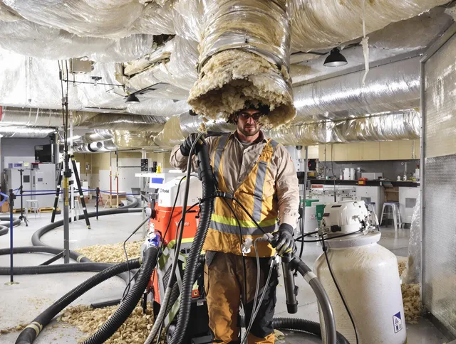 Professional vacuum insulation removal by Stoneham Air Duct Cleaning expert in Stoneham